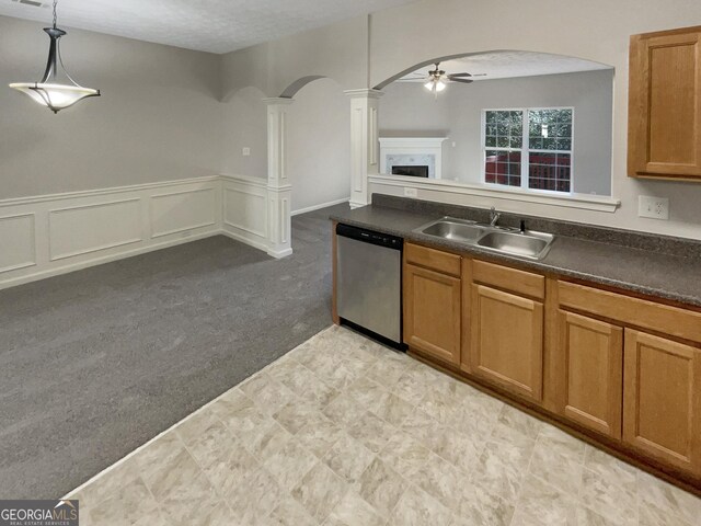 kitchen featuring light carpet, sink, stainless steel dishwasher, ceiling fan, and decorative light fixtures