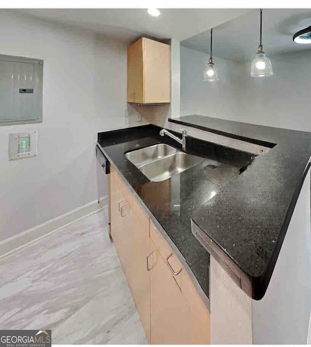 kitchen with sink, electric panel, dark stone counters, decorative light fixtures, and light brown cabinetry