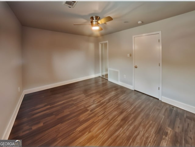 spare room with ceiling fan and dark hardwood / wood-style flooring