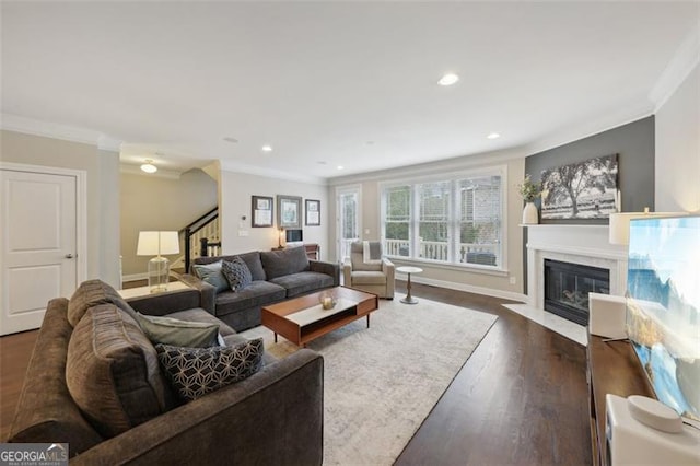 living room with crown molding and dark wood-type flooring