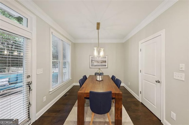 dining space featuring crown molding and dark wood-type flooring