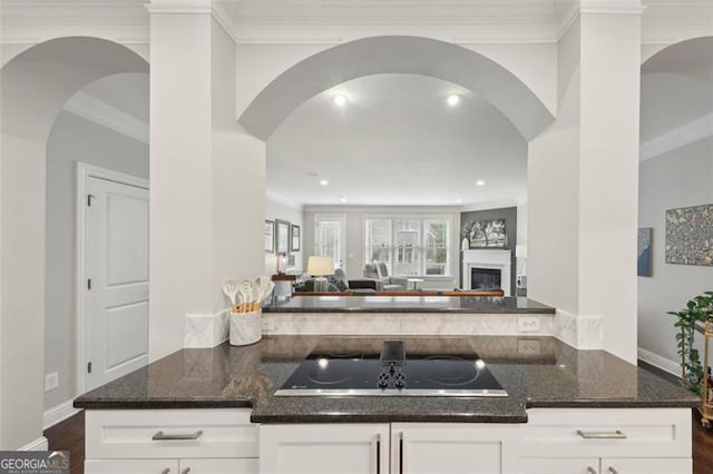 kitchen with white cabinets, dark hardwood / wood-style floors, and dark stone countertops