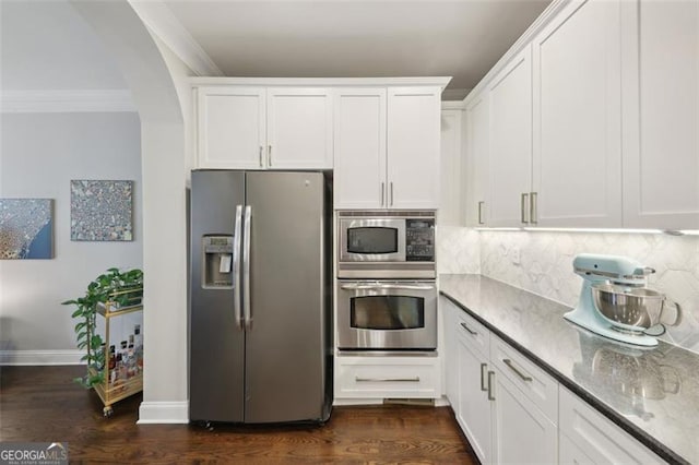 kitchen with decorative backsplash, dark hardwood / wood-style flooring, stainless steel appliances, crown molding, and white cabinets