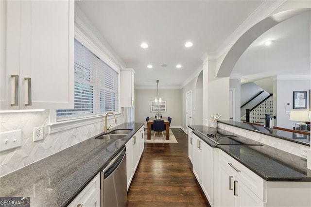 kitchen featuring dark stone countertops, white cabinets, and hanging light fixtures