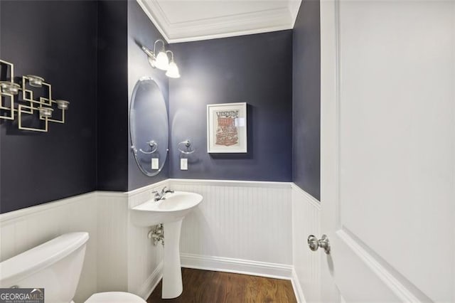 bathroom featuring hardwood / wood-style floors, toilet, and ornamental molding