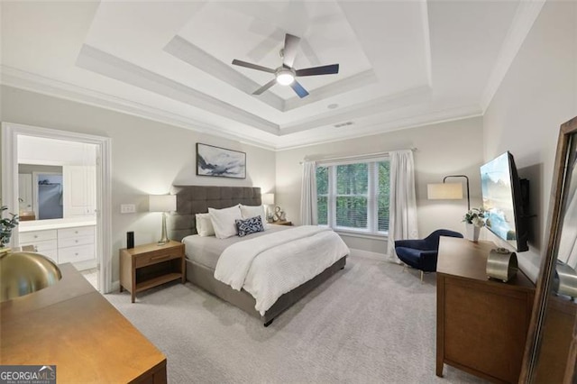 bedroom featuring a tray ceiling, ceiling fan, crown molding, and light colored carpet