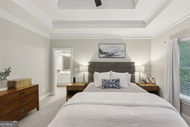 bedroom with ensuite bathroom, ceiling fan, ornamental molding, a tray ceiling, and light colored carpet