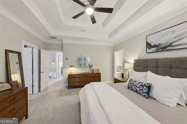 bedroom with a raised ceiling, ceiling fan, light carpet, and ornamental molding