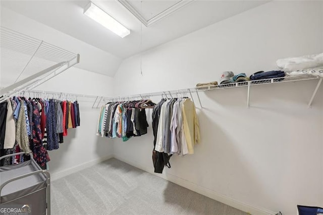 spacious closet with light carpet and lofted ceiling