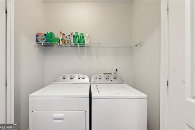 washroom with washing machine and clothes dryer