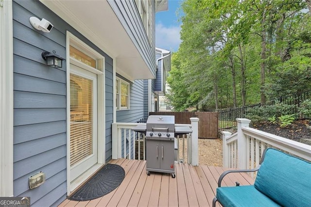 wooden deck featuring a grill