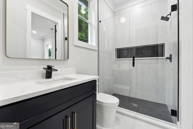 bathroom with vanity, toilet, and a shower with door