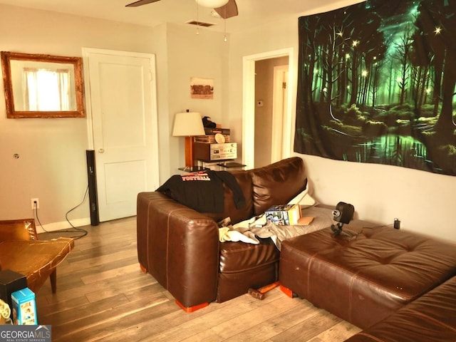 living room featuring ceiling fan and light wood-type flooring