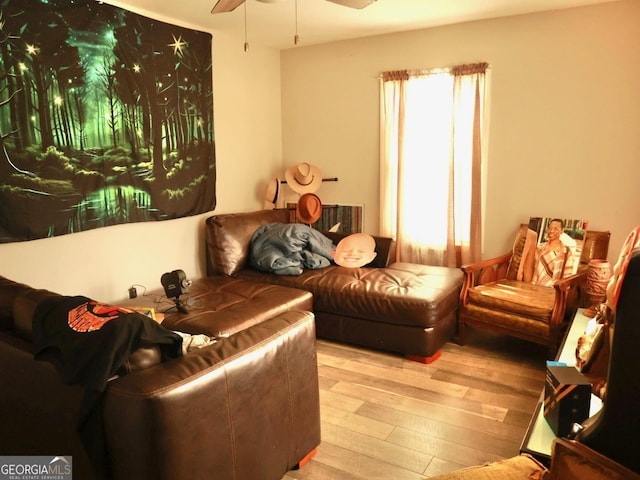 sitting room featuring ceiling fan and light wood-type flooring