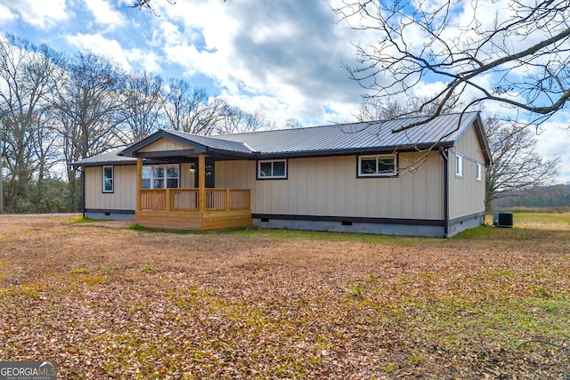 view of front facade with metal roof, crawl space, and central air condition unit