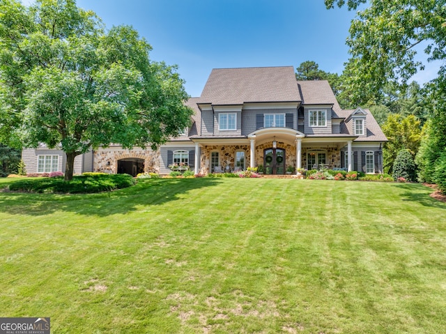 view of front of property featuring a front lawn and french doors