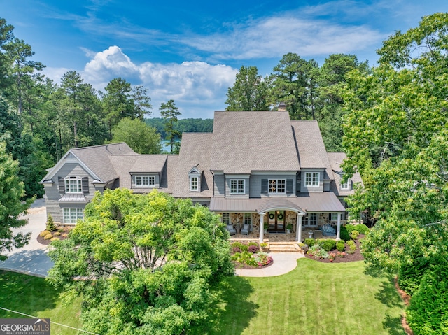 view of front of house with a porch and a front yard