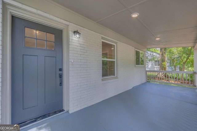 view of exterior entry featuring a porch