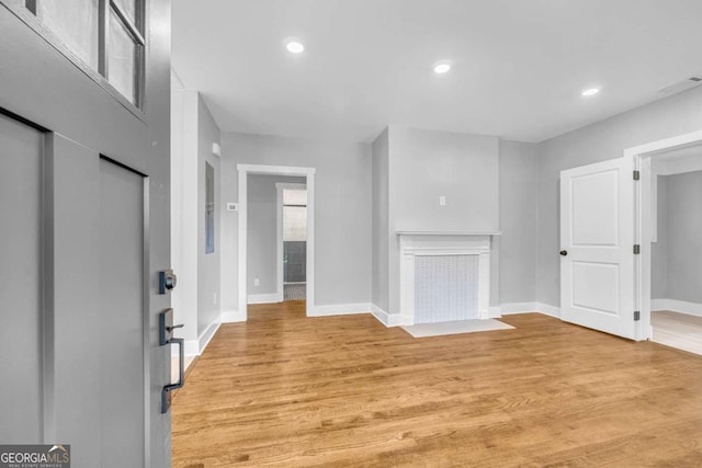 unfurnished living room with light wood-type flooring