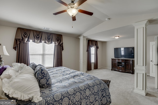 bedroom with decorative columns, ceiling fan, light carpet, and vaulted ceiling