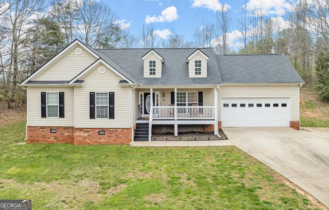 view of front of home with covered porch, a garage, and a front lawn