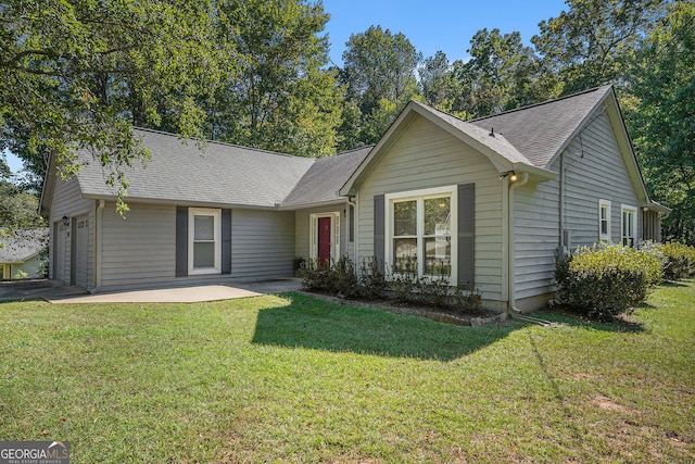 ranch-style home with a garage and a front lawn