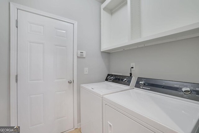 laundry area featuring washing machine and clothes dryer