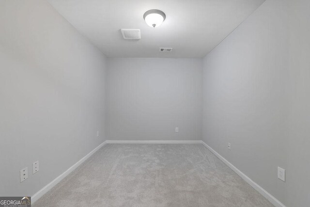 unfurnished room with light colored carpet