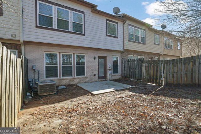 rear view of property with a patio area and cooling unit