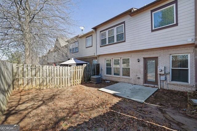 rear view of house featuring central AC and a patio area