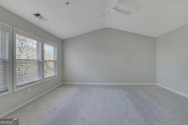 empty room with carpet flooring, ceiling fan, and vaulted ceiling