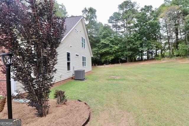 view of yard featuring central AC unit