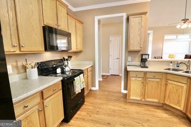 kitchen featuring ornamental molding, ceiling fan, sink, black appliances, and light hardwood / wood-style flooring