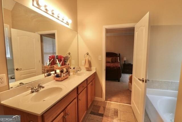 bathroom featuring a bath, vanity, and tile patterned floors