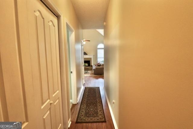 corridor featuring dark hardwood / wood-style flooring