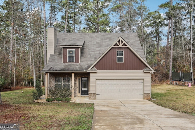 view of front of property with a garage, a trampoline, and a front lawn