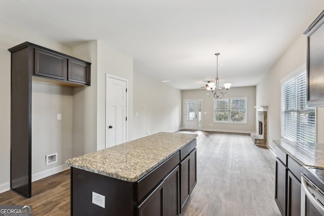 kitchen featuring range, a center island, a chandelier, and hardwood / wood-style flooring