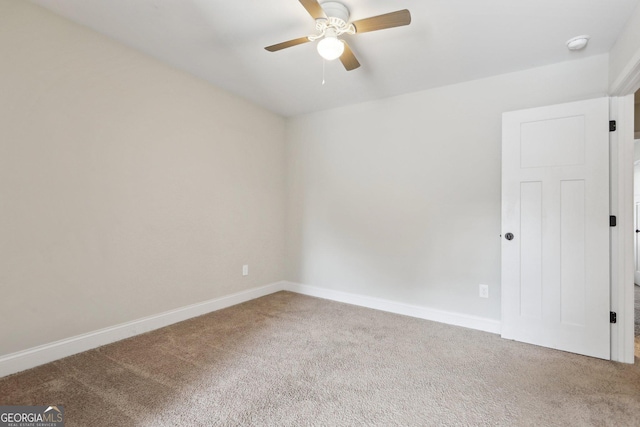 carpeted spare room with ceiling fan