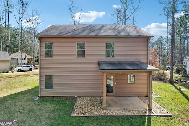 back of house featuring a patio area and a yard