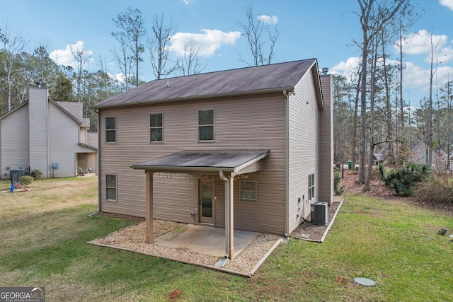 back of house featuring a yard, cooling unit, and a patio