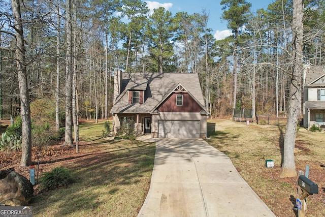 view of front of property with a front yard and a garage