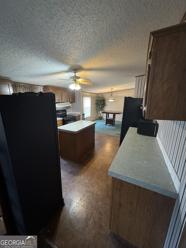 kitchen featuring black appliances, ceiling fan, a center island, and billiards