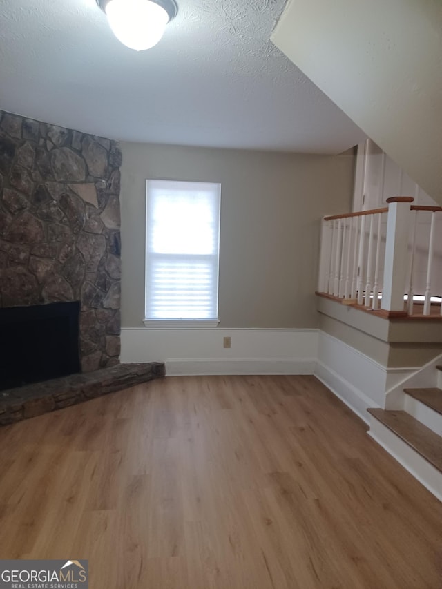 unfurnished living room featuring a fireplace and hardwood / wood-style floors