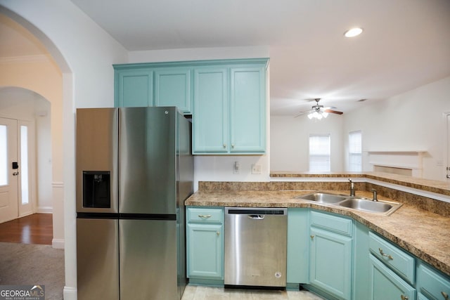 kitchen featuring ceiling fan, sink, light hardwood / wood-style flooring, and appliances with stainless steel finishes