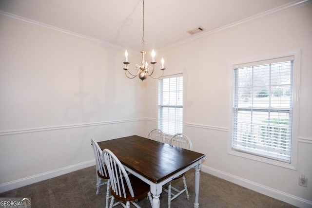 carpeted dining area featuring a notable chandelier and crown molding