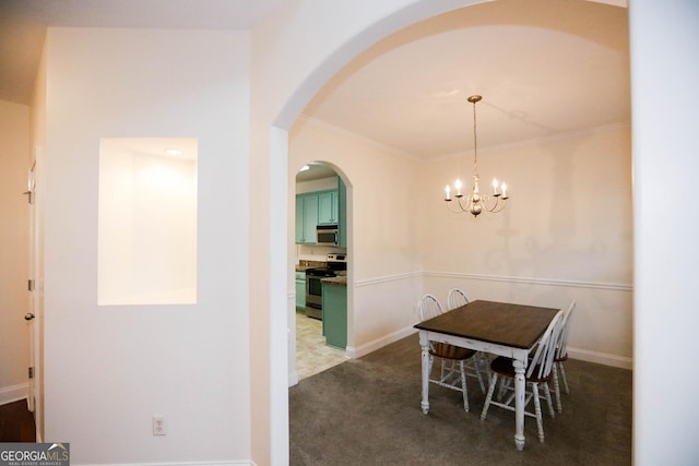 carpeted dining space featuring a chandelier and crown molding