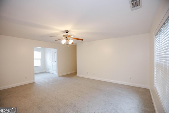 spare room featuring ceiling fan and light colored carpet