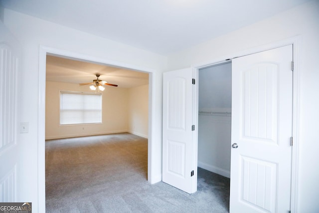 unfurnished bedroom featuring light carpet and ceiling fan