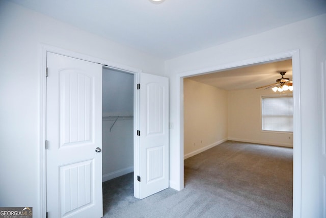 unfurnished bedroom featuring ceiling fan, a closet, and carpet floors