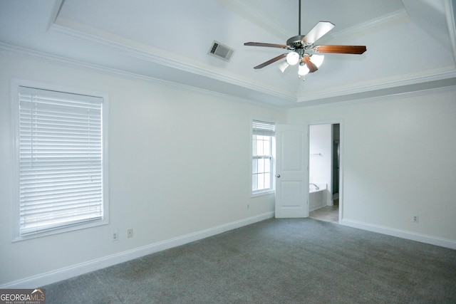 carpeted spare room with a tray ceiling, ceiling fan, and ornamental molding